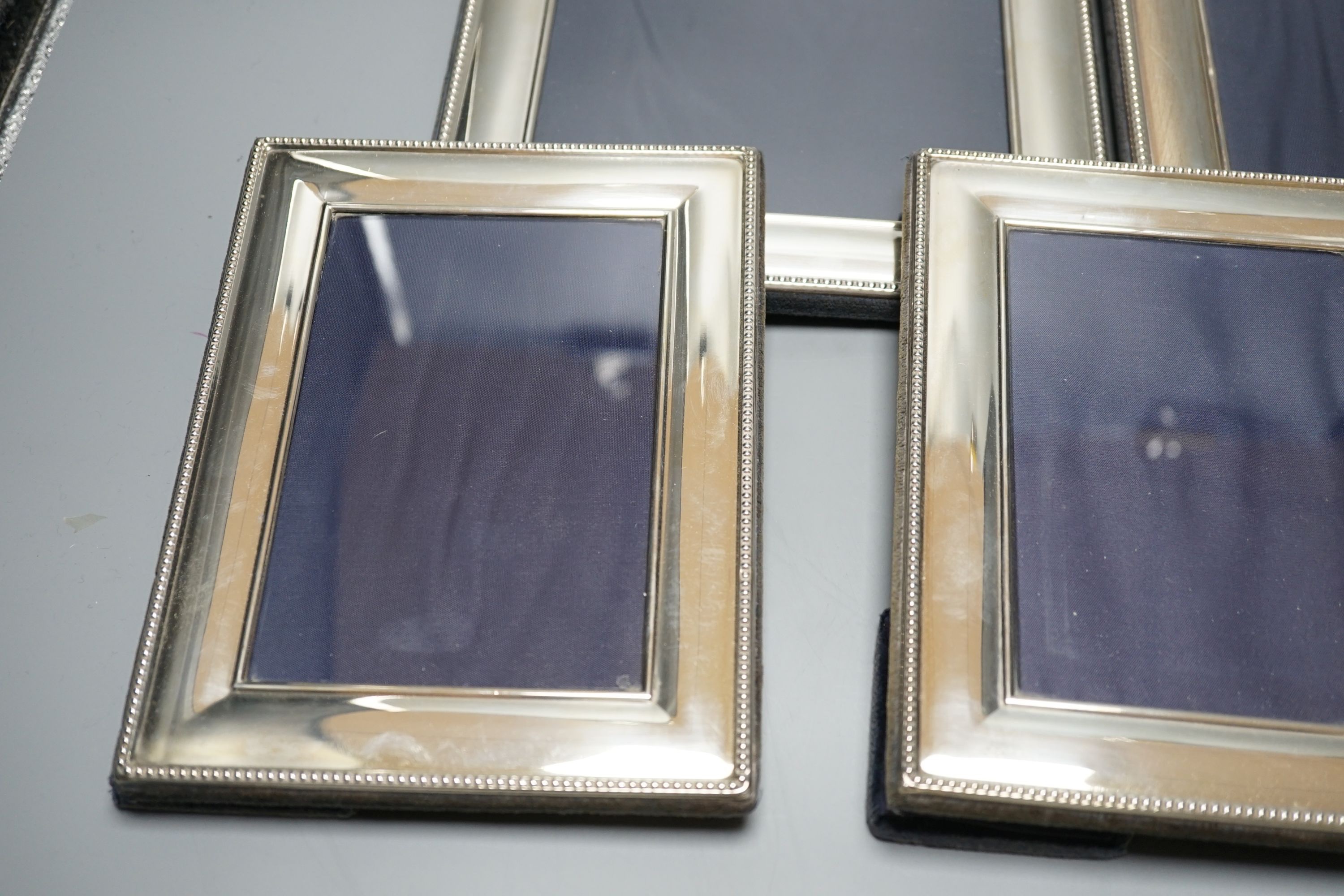 A modern pair of silver mounted photograph frames, Carrs of Sheffield, 2001, 26cm, and a set of three smaller frames, same maker, 2000, 20.2cm